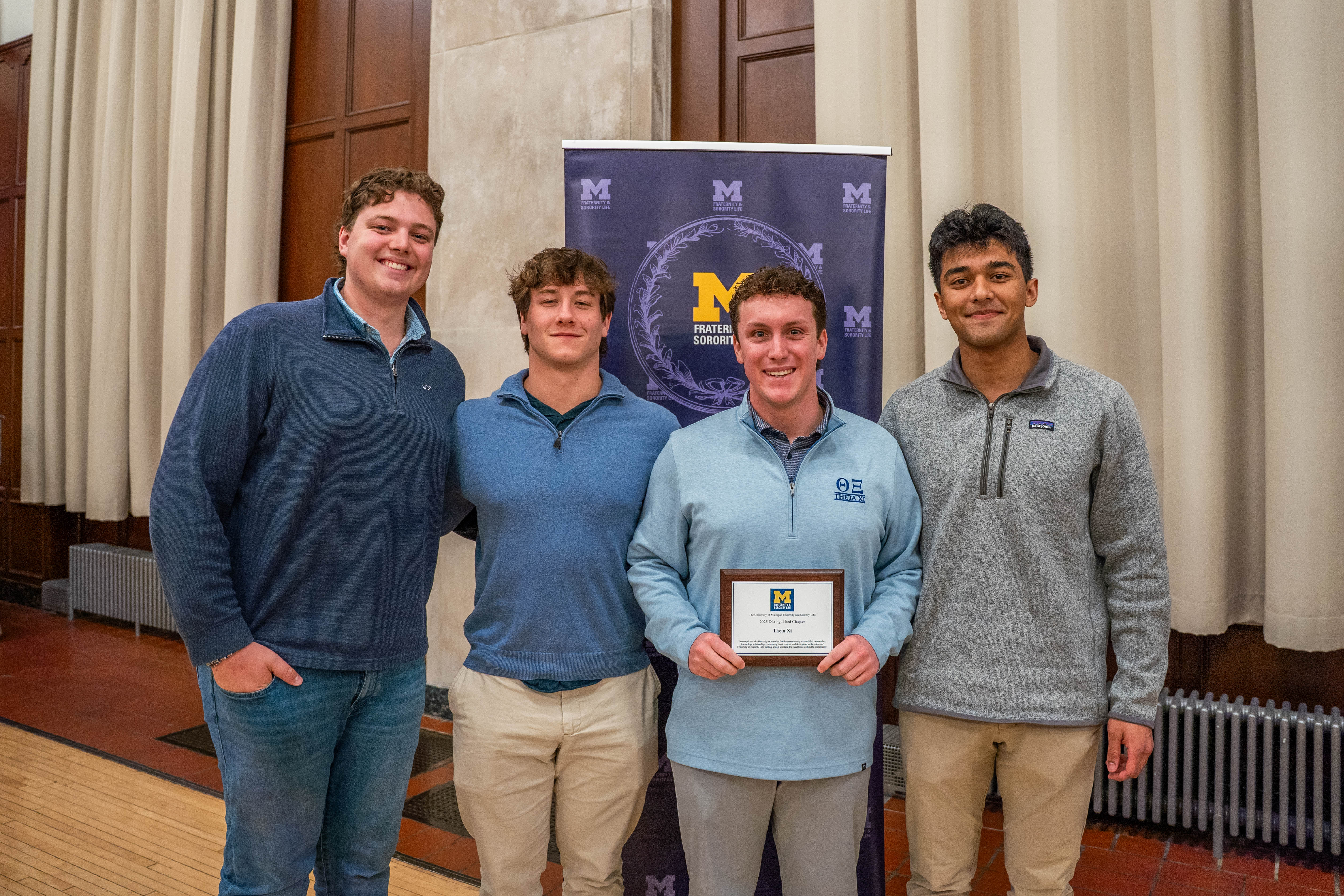 IFC fraternity members at Awards night holding award