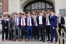 IFC fraternity posing for a photo wearing formal attire.