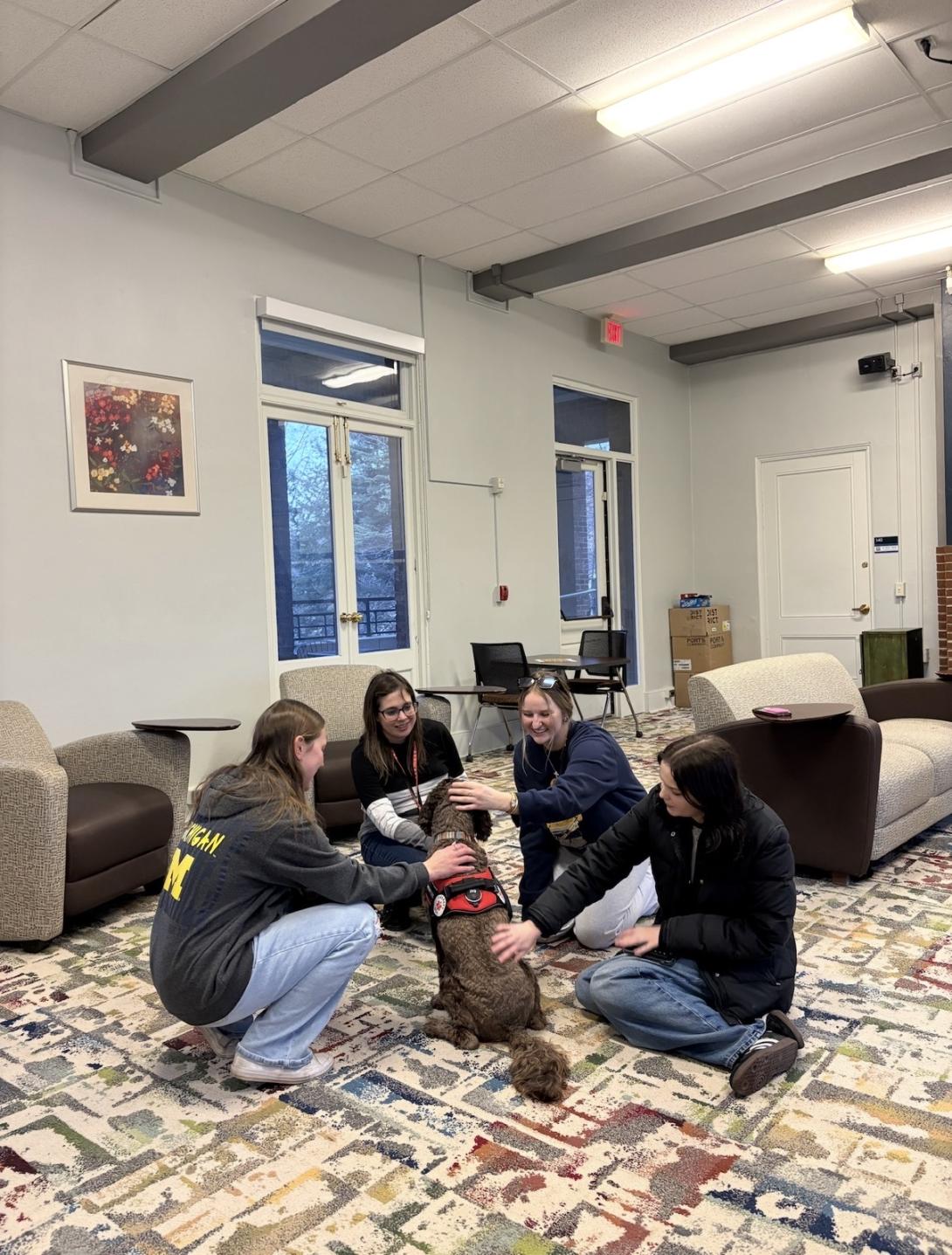Panhel members petting a dog during one of their study wellness events.